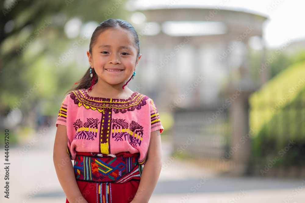 Portrait of a beautiful indigenous girl with a colorful dress from Quiché.